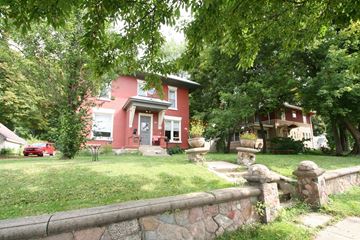 Red Wing apartment for rent - a red house with a stone fence in front of it