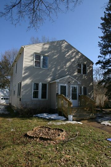 Rochester apartment for rent - the back of a house with snow on the ground