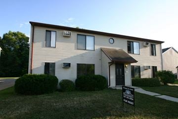 Rochester apartment for rent - a white house with a black sale sign in front of it