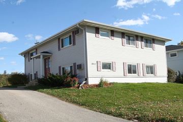 Rochester apartment for rent - A house with a grey siding and red trim.