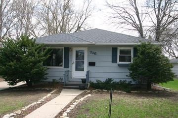 Rochester house for rent - a white house with a blue door and a sidewalk