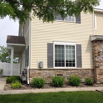 Rochester apartment for rent - A house numbered 5948 with a white fence and a window with grey shutters.