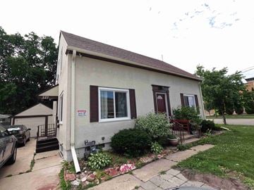 Rochester apartment for rent - A small house with a red door and a window with a white frame.