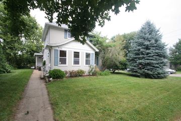 Rochester apartment for rent - A white house with a blue trim and a small porch.