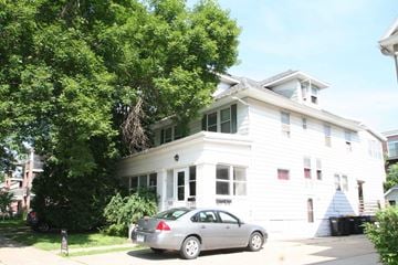 Rochester apartment for rent - a white house with a car parked in front of it