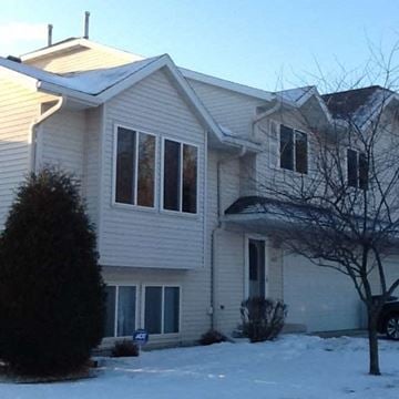 Rochester apartment for rent - A house with a snow covered front yard.