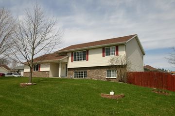 Rochester house for rent - A house with a brown roof and a white fence.