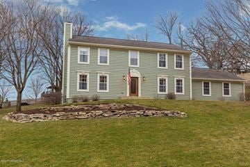 Rochester house for rent - a green house on top of a green hill