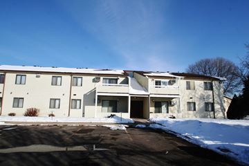 Rochester apartment for rent - A large apartment building with a parking lot in front.