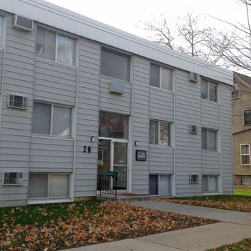 Rochester apartment for rent - a white apartment building with a sidewalk in front of it