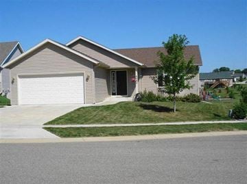 Rochester house for rent - a house with a driveway and a garage door