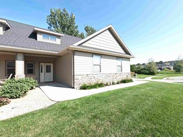 Rochester apartment for rent - A house with a grey roof and a white door.