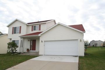 Rochester house for rent - A white house with a red door and a garage door.