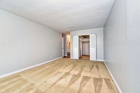 San Diego apartment for rent - a spacious living room with wood flooring and white walls