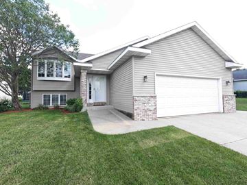 Rochester house for rent - a home with a white garage door and a driveway