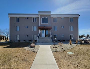Kasson apartment for rent - a large building with a sidewalk in front of it