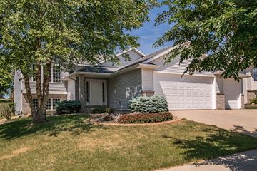 Rochester house for rent - a white house with a driveway and a garage door