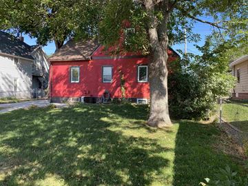 Rochester house for rent - a red house with a tree in the yard