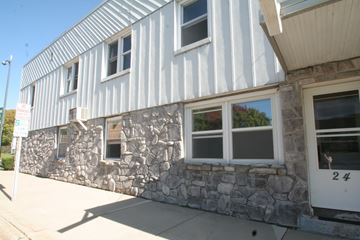 Chatfield apartment for rent - the side of a building with a stone facade and white windows