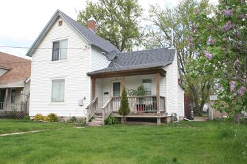 Rochester house for rent - a white house with a porch on a lawn