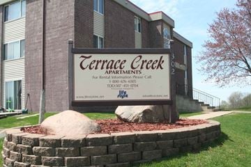 Kasson apartment for rent - the sign in front of the building of courage creek apartments
