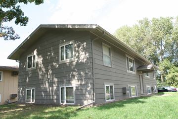 Rochester apartment for rent - the side of a house with a lawn and trees