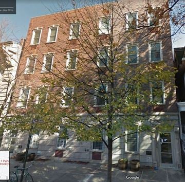 Brooklyn apartment for rent - A tree in front of a building with a bicycle leaning against a post.