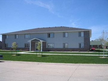 Kearney apartment for rent - a large white house with a driveway and grass