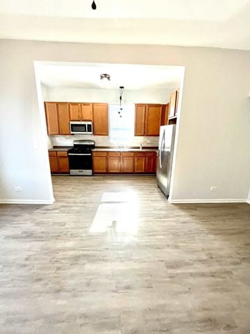 Chicago apartment for rent - an empty kitchen with wooden cabinets and stainless steel appliances