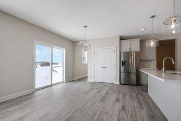 Hugo house for rent - an open kitchen and living room with a stainless steel refrigerator