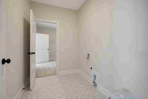 Lake Elmo house for rent - an empty room with white walls and a door open to a bathroom