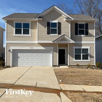 Charlotte house for rent - a tan house with a white garage door