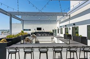 Burbank apartment for rent - a large patio with chairs and tables and a pool