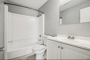 North Fort Myers apartment for rent - A white bathroom with a toilet, sink, and shower.
