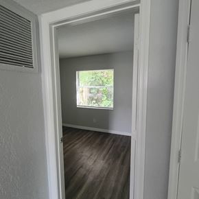 Fort Myers apartment for rent - A room with a window and a wooden floor.