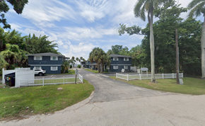 Fort Myers apartment for rent - A residential area with houses and a white fence.