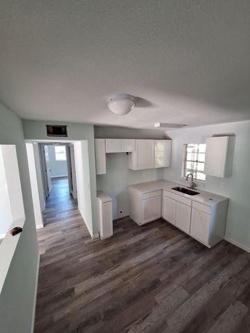 Fort Myers apartment for rent - A kitchen with white cabinets and a sink.