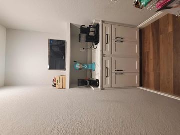 Gulf Breeze house for rent - a living room with a white carpet and a white door
