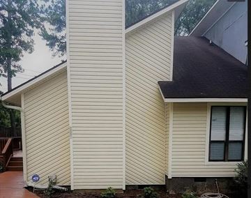 Fayetteville house for rent - a yellow house with white siding on the side of it