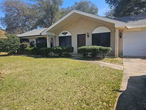Pensacola house for rent - A house with a driveway and a garage.