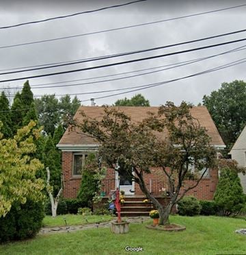 Iselin apartment for rent - a brick house with a yard and a tree in front of it