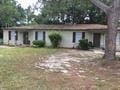 Pensacola house for rent - a small white house with a tree in front of it