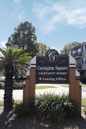 Metairie townhouse for rent - A sign for Covington Square Apartment Homes with a leasing office direction.