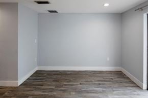 Bradenton apartment for rent - A room with a grey floor and white walls.