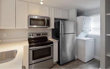 Bradenton apartment for rent - A kitchen with white cabinets and stainless steel appliances.