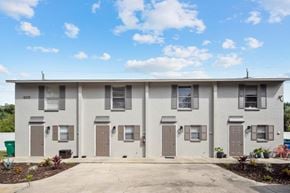Bradenton apartment for rent - A row of identical houses with brown doors and windows.