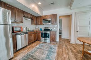 Baton Rouge apartment for rent - a kitchen with stainless steel appliances and wooden cabinets