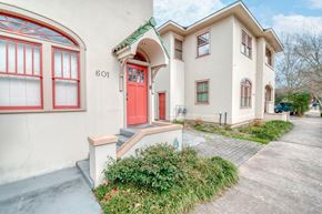 Baton Rouge apartment for rent - a white building with a red door and a sidewalk