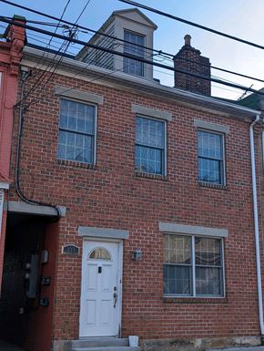 Pittsburgh apartment for rent - A red brick house with a white door and windows.