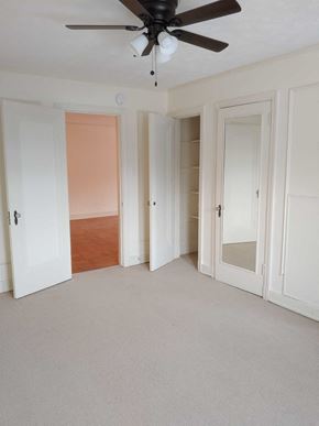 Pittsburgh apartment for rent - A room with a ceiling fan and white walls.